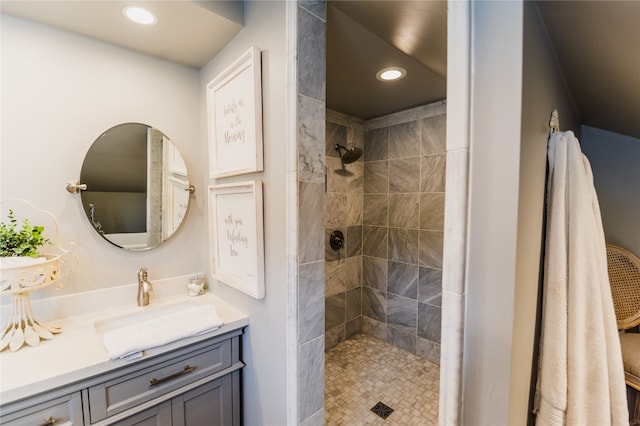 bathroom with vanity and tiled shower