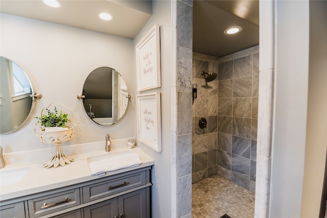 bathroom featuring vanity and tiled shower