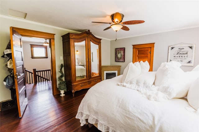 bedroom featuring ornamental molding, dark hardwood / wood-style flooring, and ceiling fan