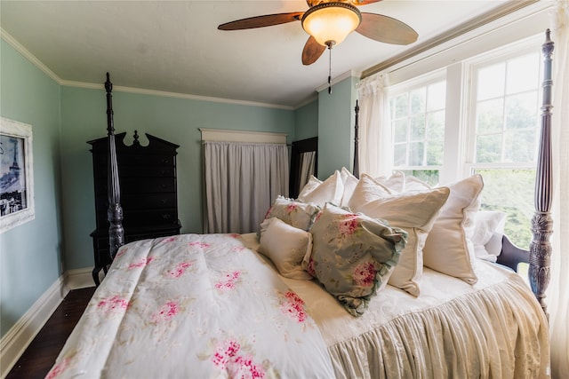 bedroom with ornamental molding, ceiling fan, and dark wood-type flooring