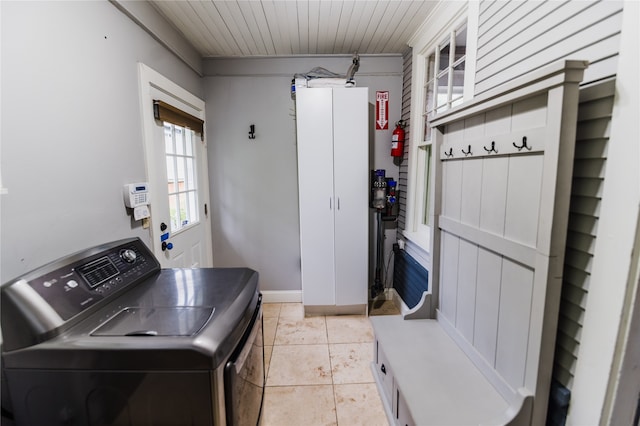 washroom featuring washer / clothes dryer and light tile patterned floors