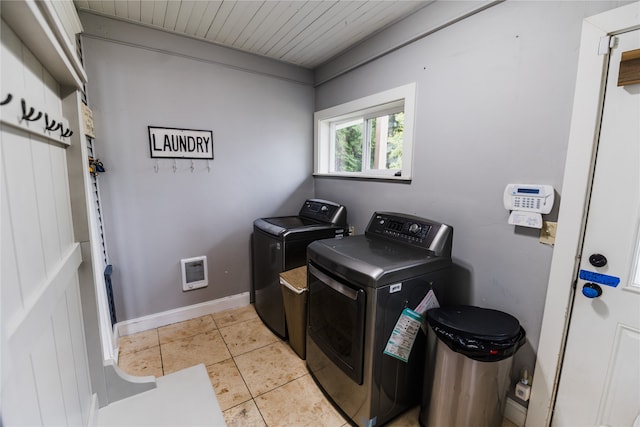 laundry room featuring separate washer and dryer and light tile patterned floors