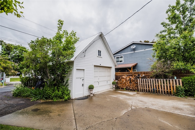 view of side of home with a garage and an outdoor structure