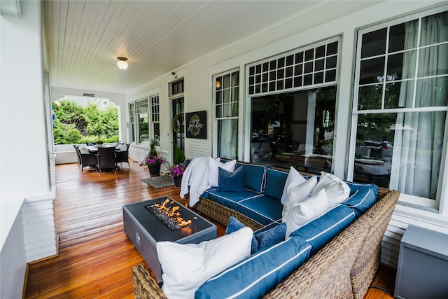 wooden deck with an outdoor living space with a fire pit