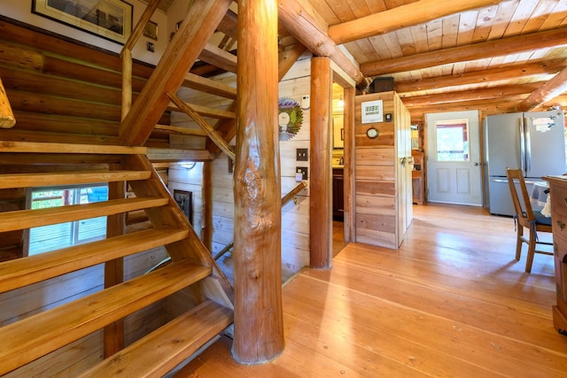 staircase with wooden ceiling and hardwood / wood-style flooring