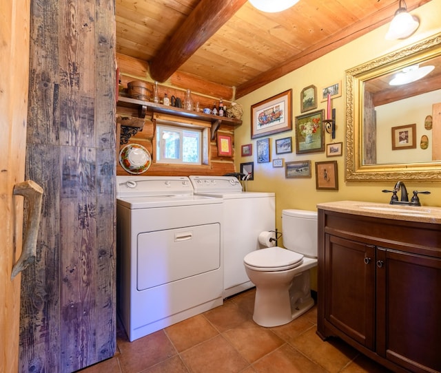 bathroom with toilet, washing machine and clothes dryer, tile patterned flooring, wooden ceiling, and vanity