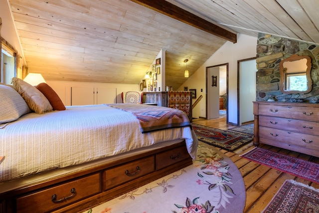 bedroom with light wood-type flooring, lofted ceiling with beams, and wood ceiling