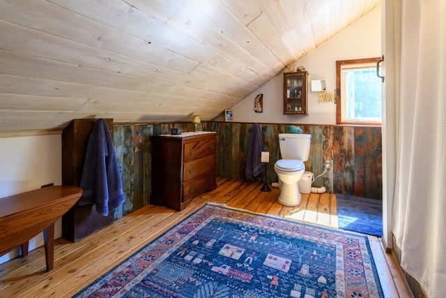 bathroom with hardwood / wood-style floors, vaulted ceiling, wood ceiling, and toilet