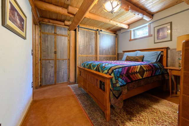 carpeted bedroom with a barn door, beam ceiling, and wood ceiling