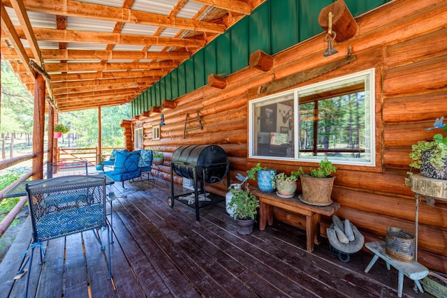 wooden deck with grilling area and an outdoor living space