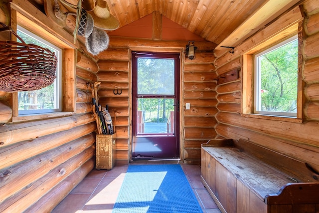 interior space featuring wood ceiling, rustic walls, lofted ceiling, and light tile patterned floors