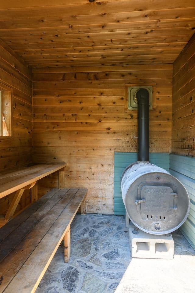 view of sauna with wooden walls and wood ceiling