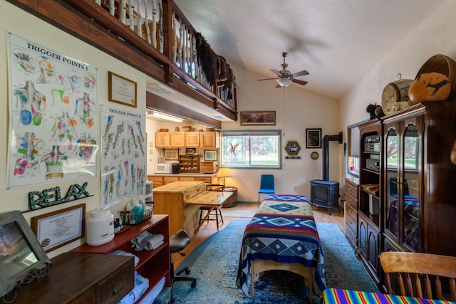 5899 Black Lake Rd, Rexford, MT 59930 - living area featuring ceiling fan, vaulted ceiling, a wood stove, and light wood-style floors