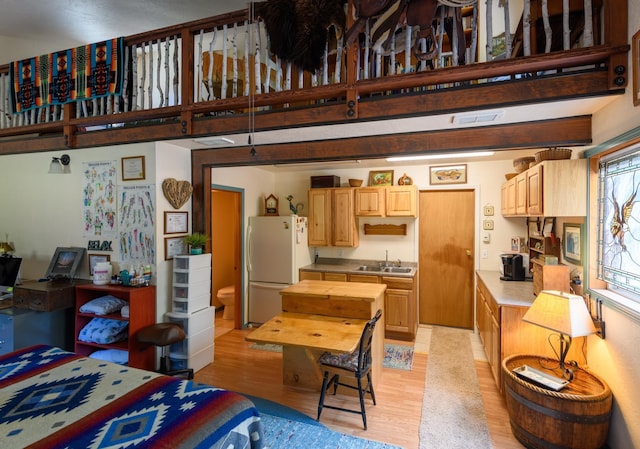 5899 Black Lake Rd, Rexford, MT 59930 - kitchen featuring light countertops, a sink, light wood finished floors, freestanding refrigerator, and light brown cabinets