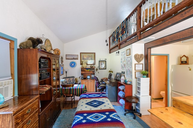 home office featuring wood-type flooring and high vaulted ceiling