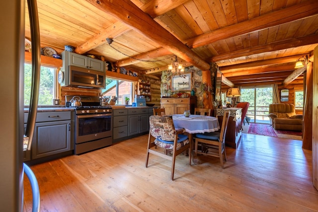 kitchen with light hardwood / wood-style flooring, rustic walls, gas stove, and wood ceiling