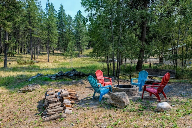 view of yard with an outdoor fire pit