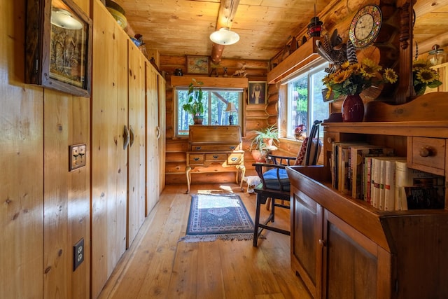 entryway with rustic walls, light wood-type flooring, and wooden ceiling