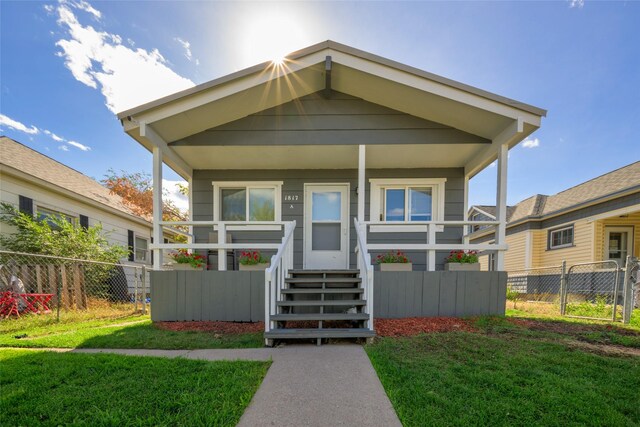 view of front of property with a porch and a front lawn