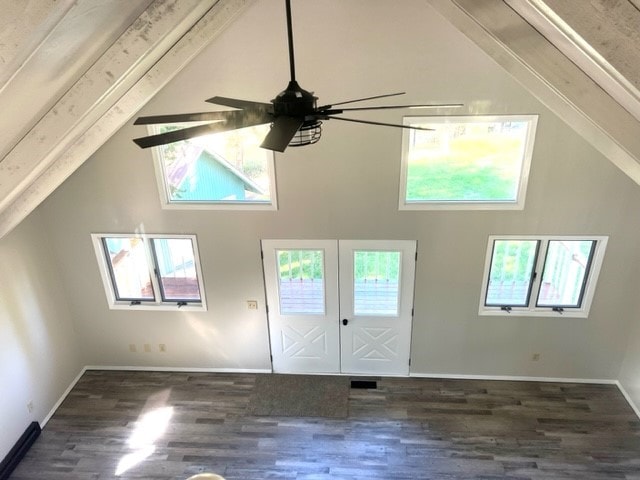 interior space featuring ceiling fan, a wealth of natural light, and dark hardwood / wood-style flooring