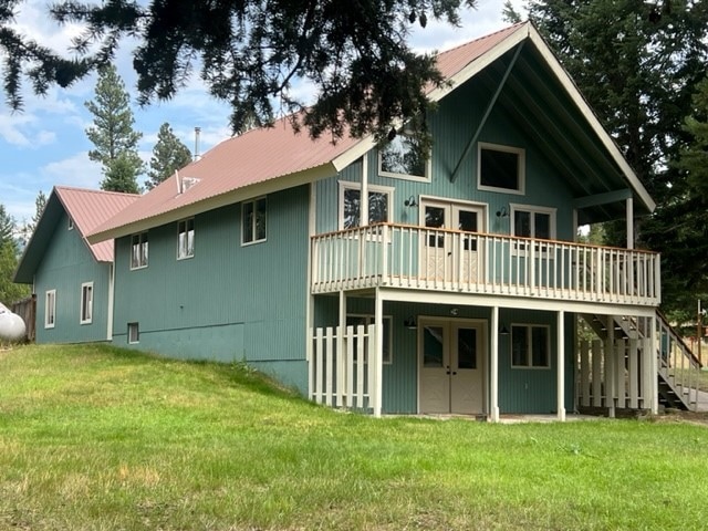 rear view of property with a yard