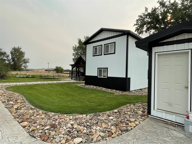 exterior space featuring a lawn and an outbuilding