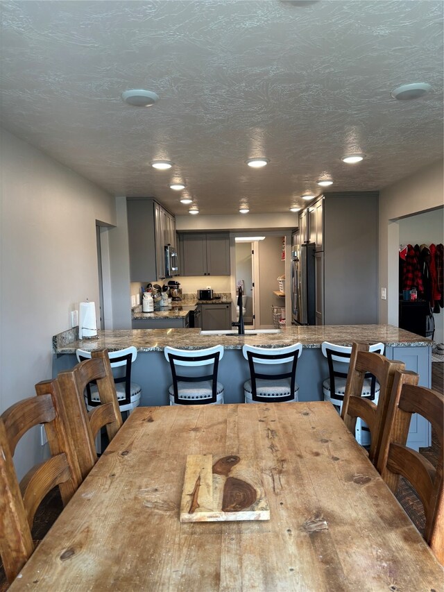 dining room with sink and a textured ceiling