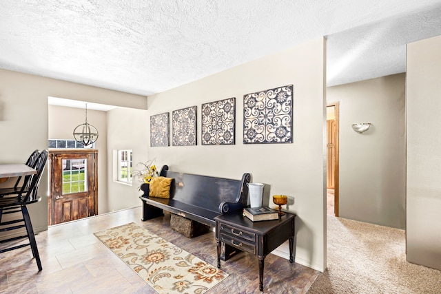 office area with a textured ceiling and a chandelier