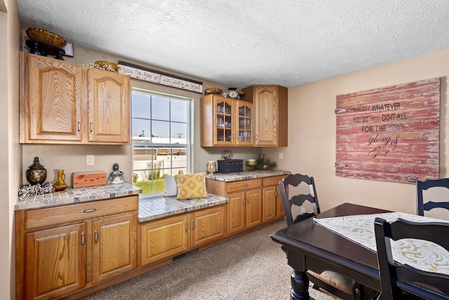 kitchen with light carpet and a textured ceiling