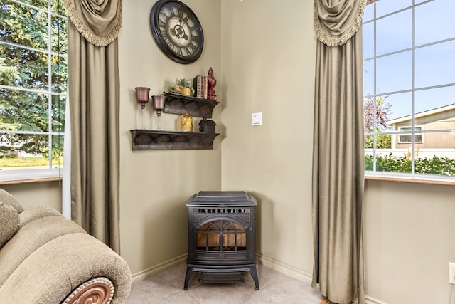 interior space with light tile patterned floors and a wood stove