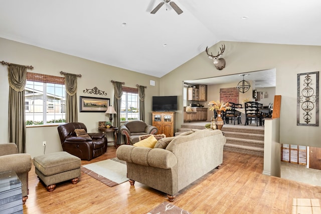 living room with lofted ceiling, light hardwood / wood-style flooring, and ceiling fan