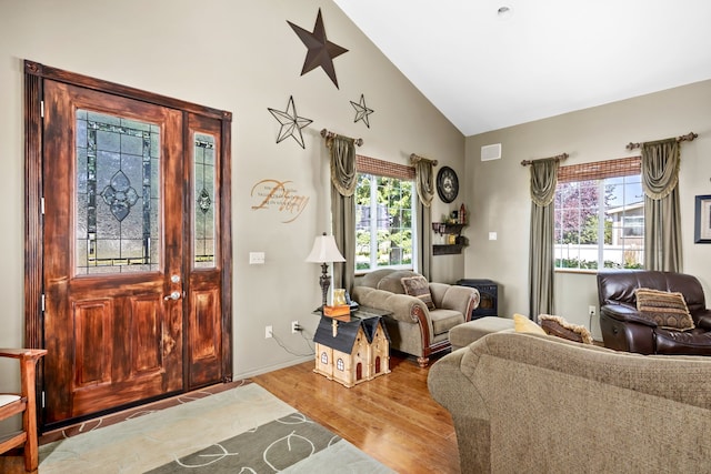 entrance foyer featuring lofted ceiling and light hardwood / wood-style flooring