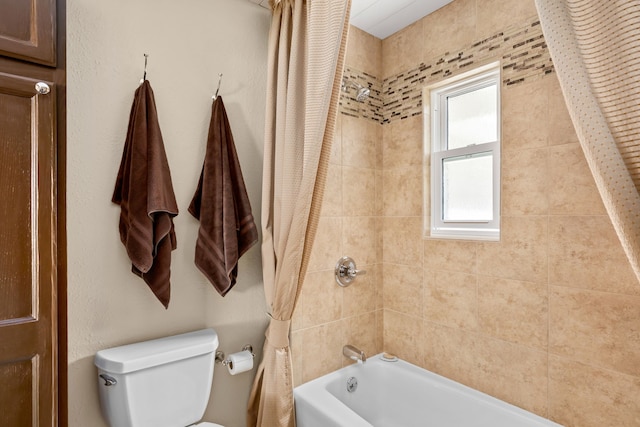 bathroom featuring toilet and shower / bath combo with shower curtain