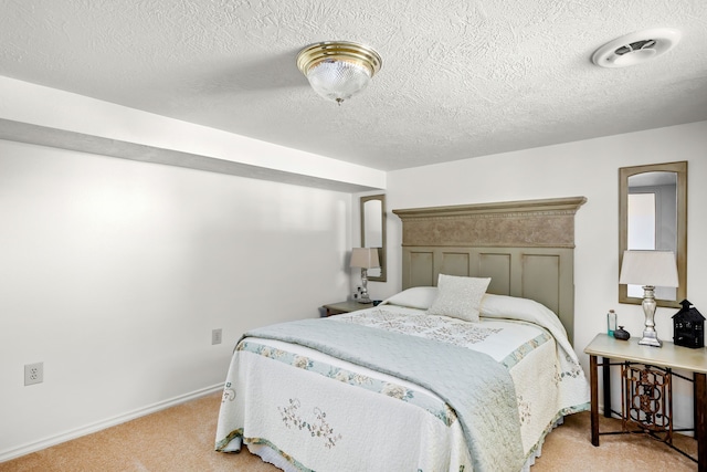 carpeted bedroom with a textured ceiling