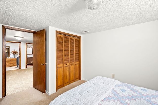 bedroom with light carpet, a textured ceiling, and a closet