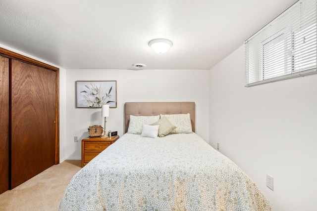 carpeted bedroom featuring a closet