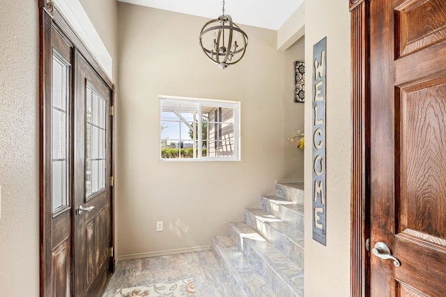 entryway with a chandelier