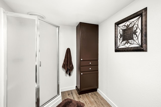 hallway with light hardwood / wood-style flooring