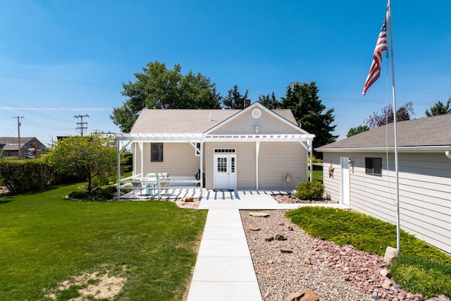 back of house featuring a pergola and a lawn