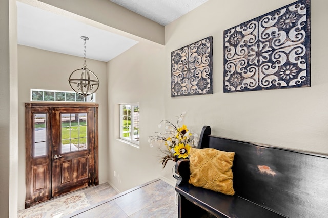 foyer entrance with a chandelier