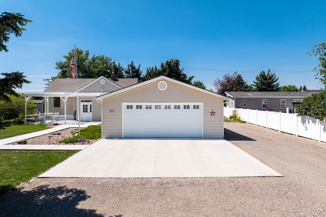 view of front of property with a garage and an outbuilding