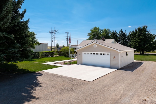 garage featuring a lawn