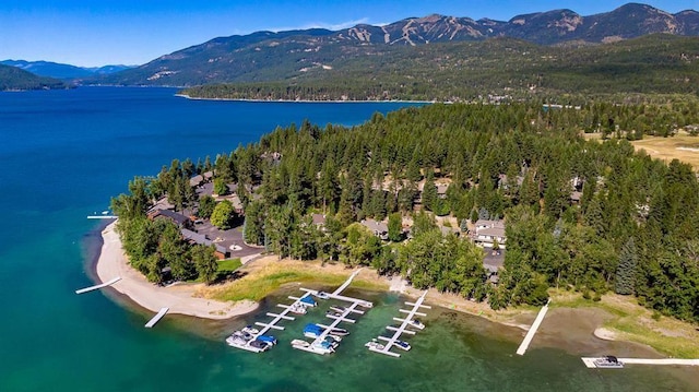 drone / aerial view featuring a water and mountain view