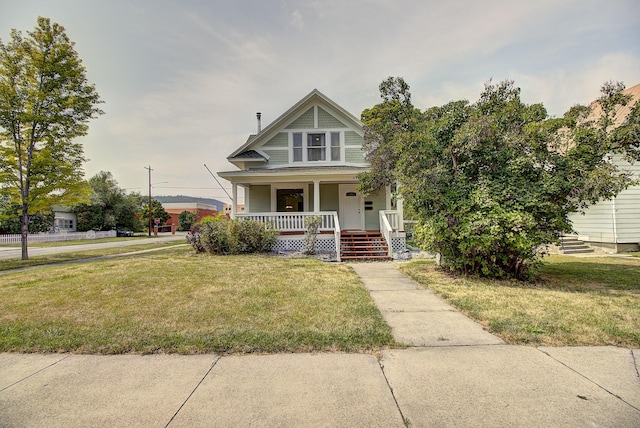 view of front of property with a porch and a front yard