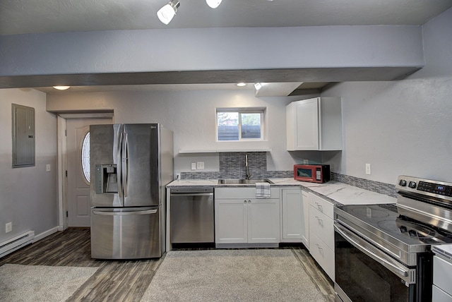 kitchen featuring sink, white cabinetry, appliances with stainless steel finishes, hardwood / wood-style flooring, and a baseboard heating unit