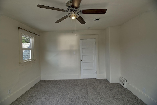 spare room with carpet floors and ceiling fan