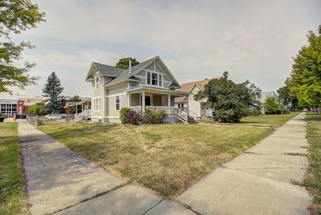 view of front of house with a porch and a front lawn