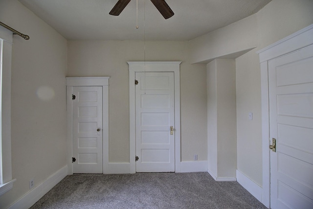 unfurnished bedroom featuring ceiling fan and carpet