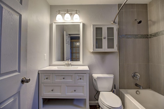 full bathroom featuring vanity, toilet, and tiled shower / bath