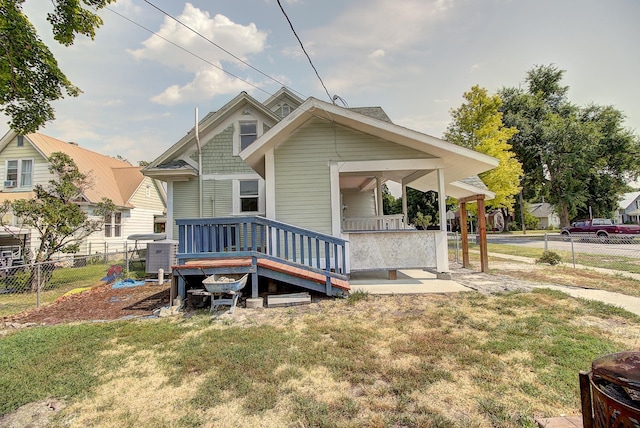 rear view of house featuring a lawn